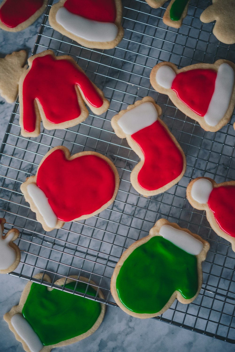 a cooling rack filled with decorated cookies on top of a table
