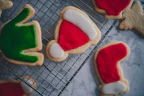 Holiday-themed cookies with festive icing and sprinkles on a cozy kitchen counter