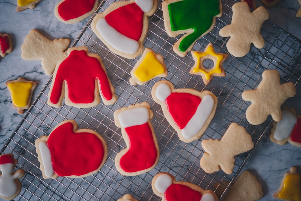 decorated cookies on a cooling rack on a table