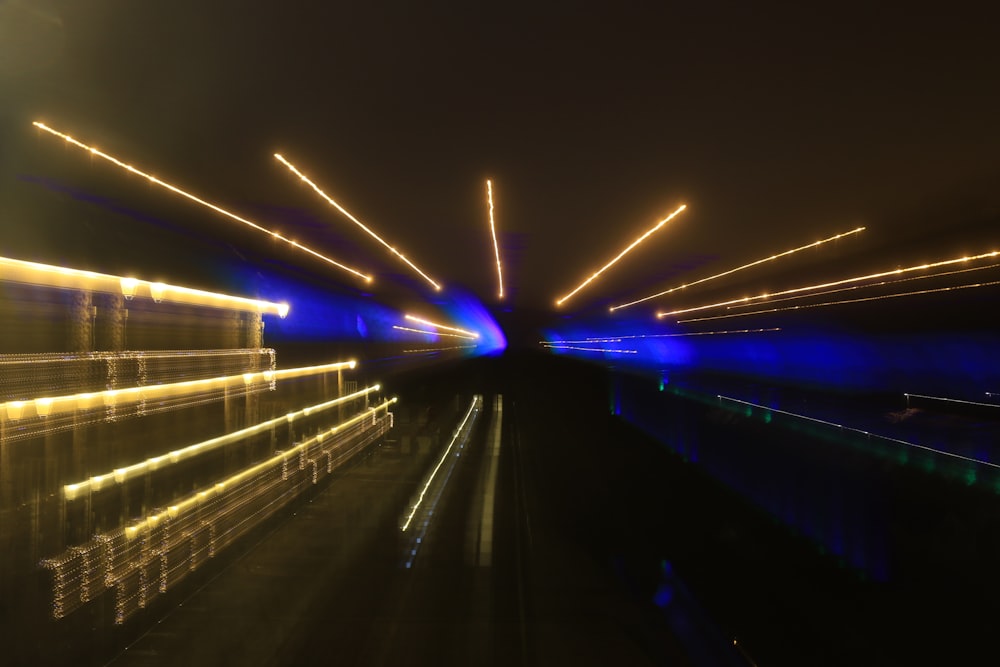 a long exposure photo of a tunnel at night