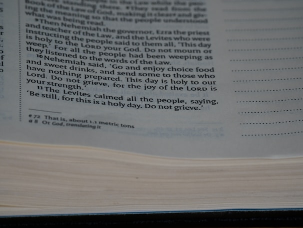 A close-up view of a page from a book containing printed text. The text discusses a religious or historical narrative, mentioning Nehemiah, the Levites, and the importance of a holy day. The page is open with some lines highlighted or bolded for emphasis.