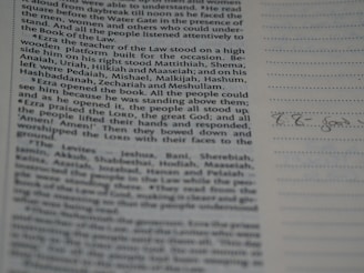 A proofreader marking corrections on a printed document.