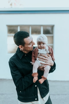 a man holding a baby in his arms