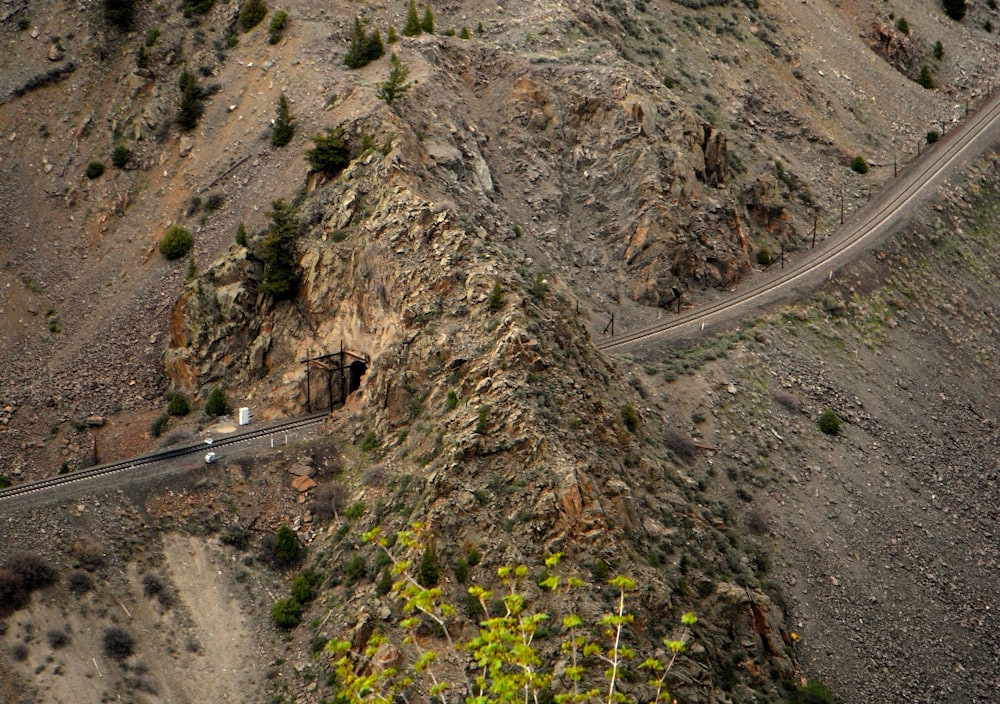 an aerial view of a winding road in the mountains