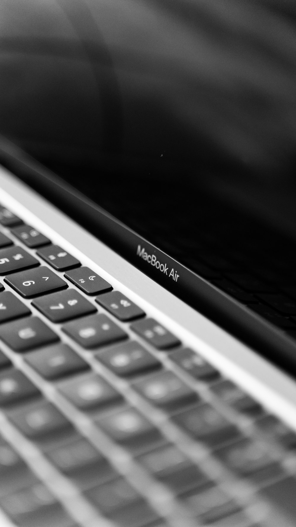 a black and white photo of a macbook air
