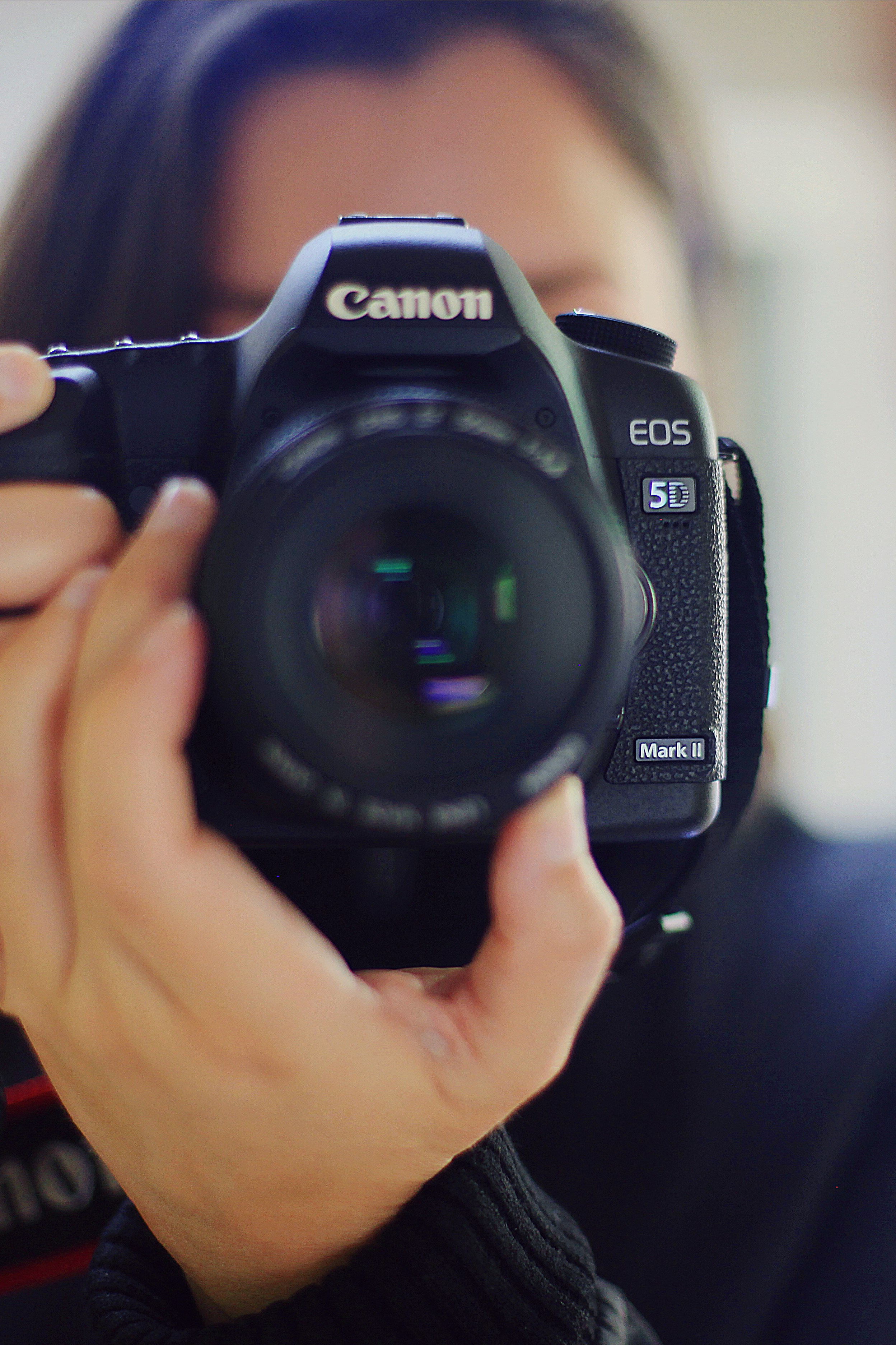 a woman taking a picture with a canon camera