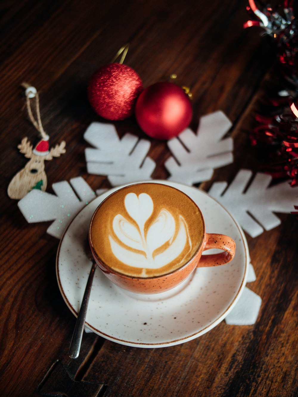 a cappuccino on a saucer with a spoon