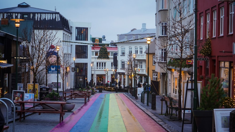 a rainbow painted street in the middle of a city