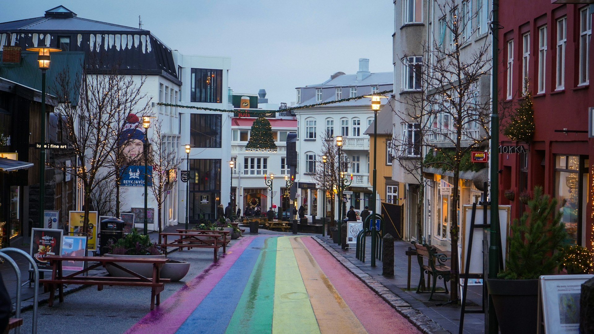 Rainbow-painted Skolavordustigur street in downtown Reykjavik lined with shops and cafes