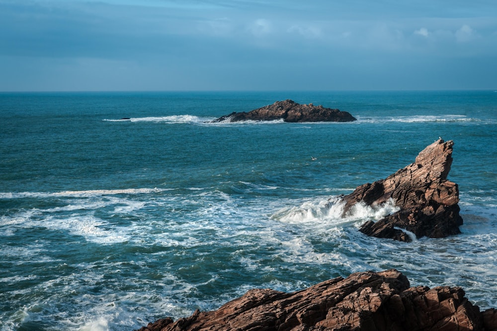 a rock outcropping in the middle of the ocean