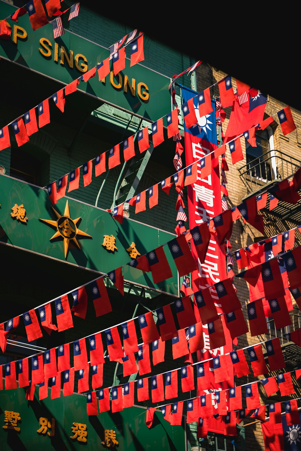 a building with a lot of red and blue flags hanging from it's sides