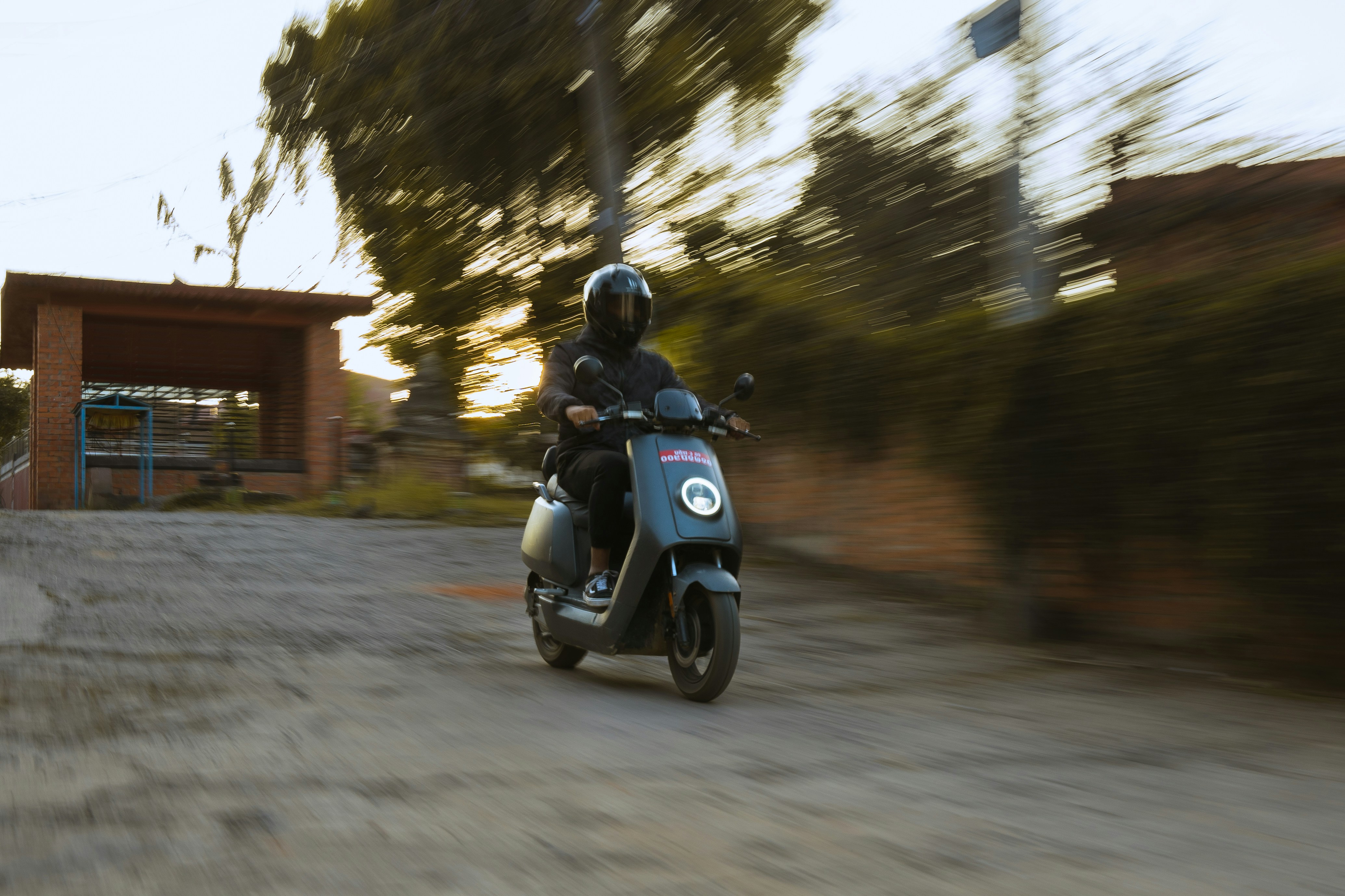 a person riding a scooter on a dirt road