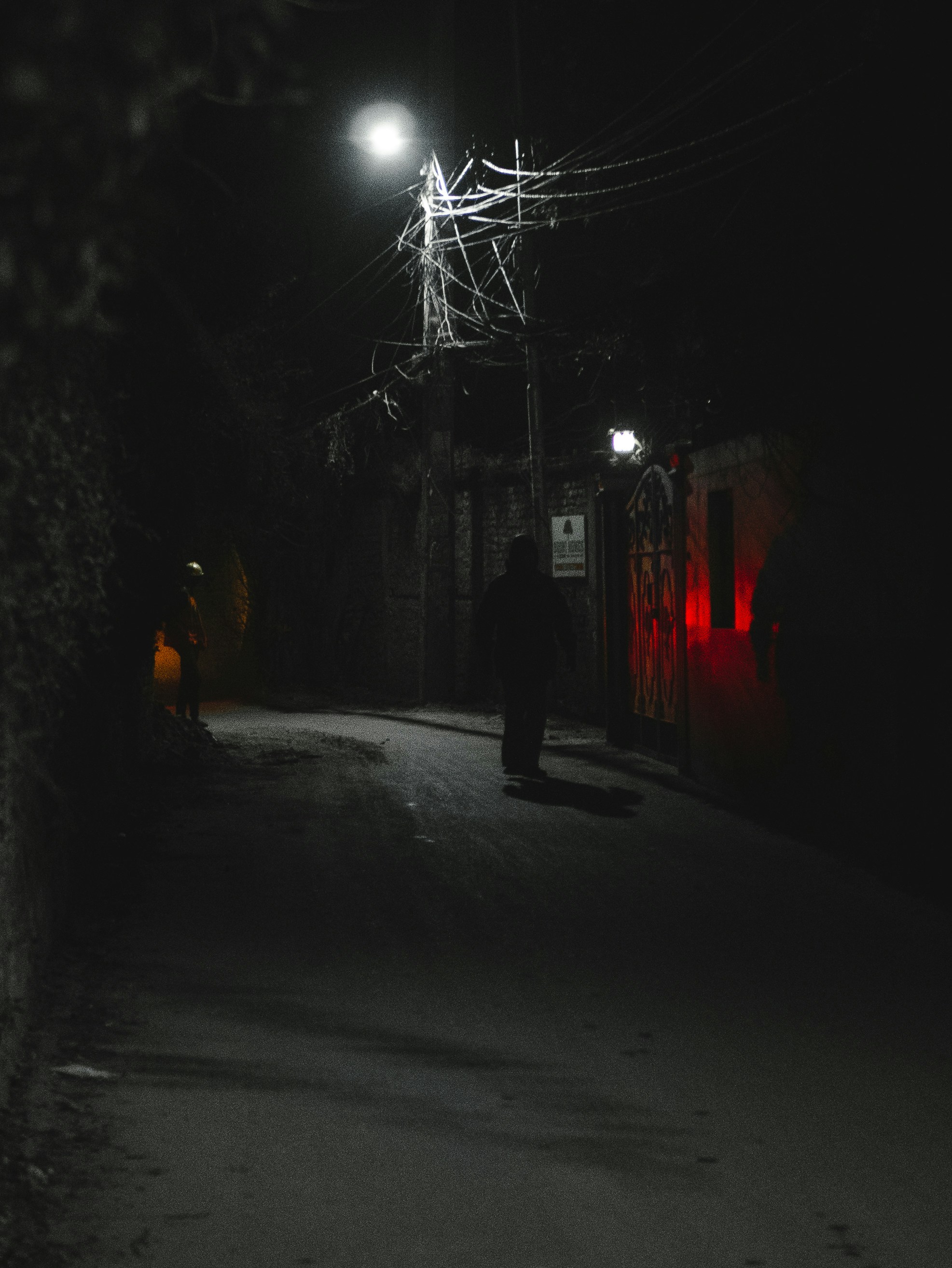 a person walking down a dark street at night