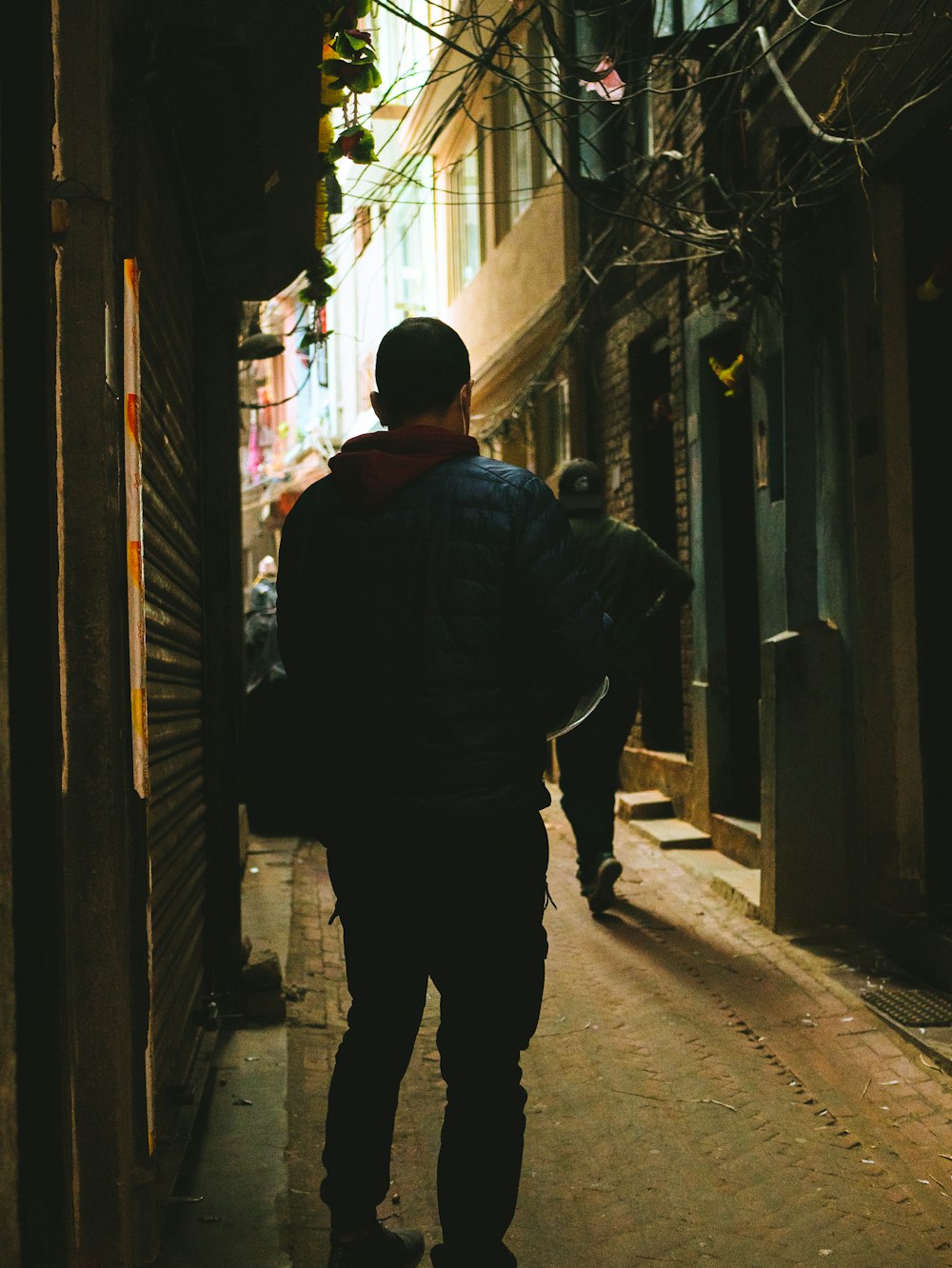 Un hombre caminando por un callejón estrecho