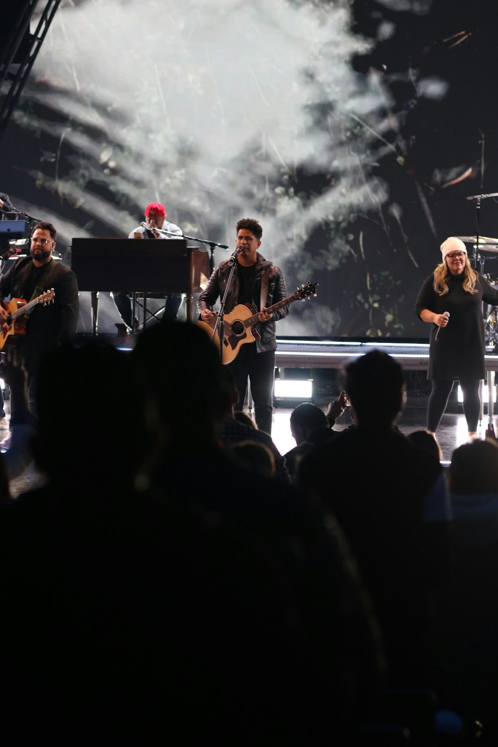 a group of people on a stage in front of a crowd