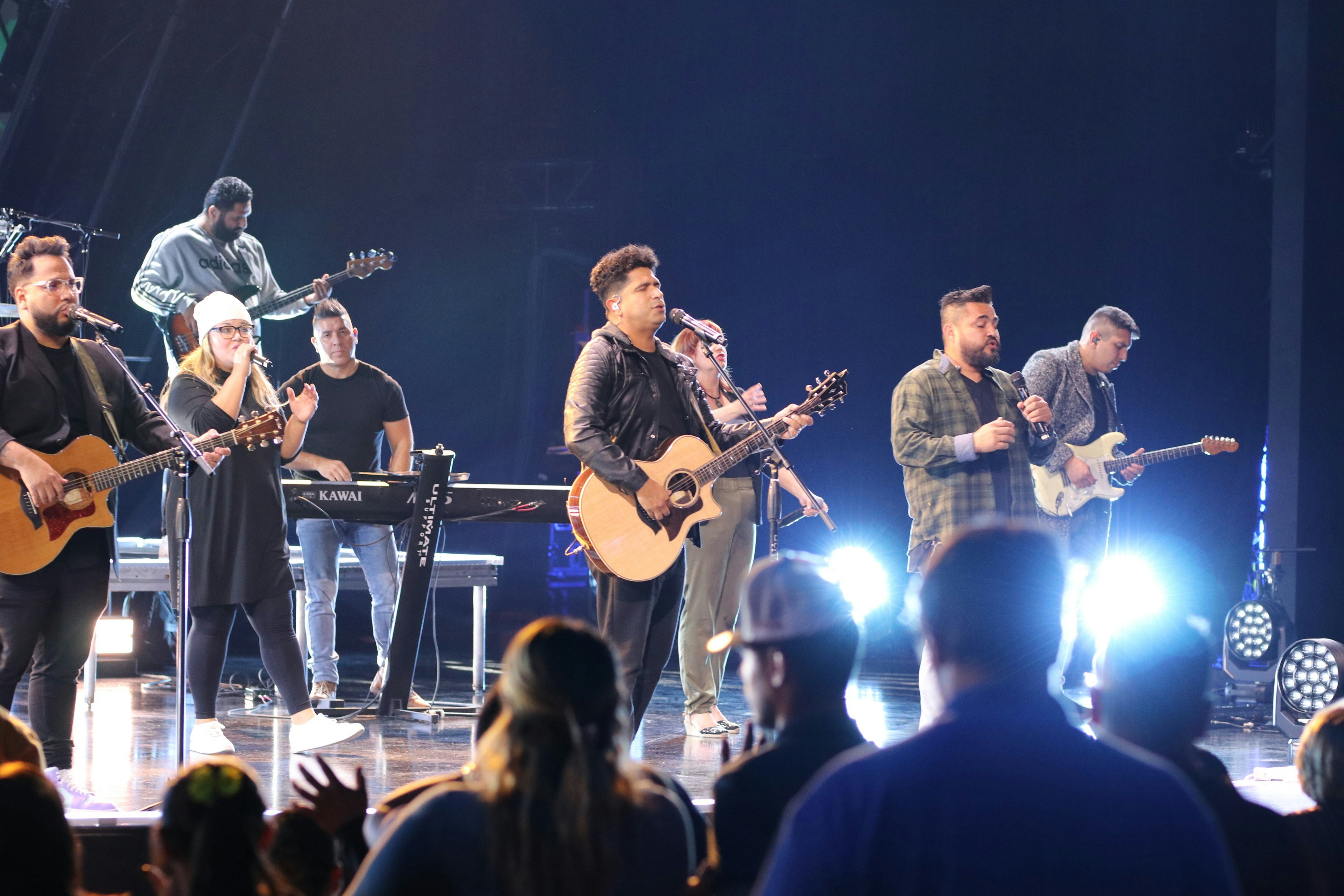 a group of people standing on a stage in front of a crowd