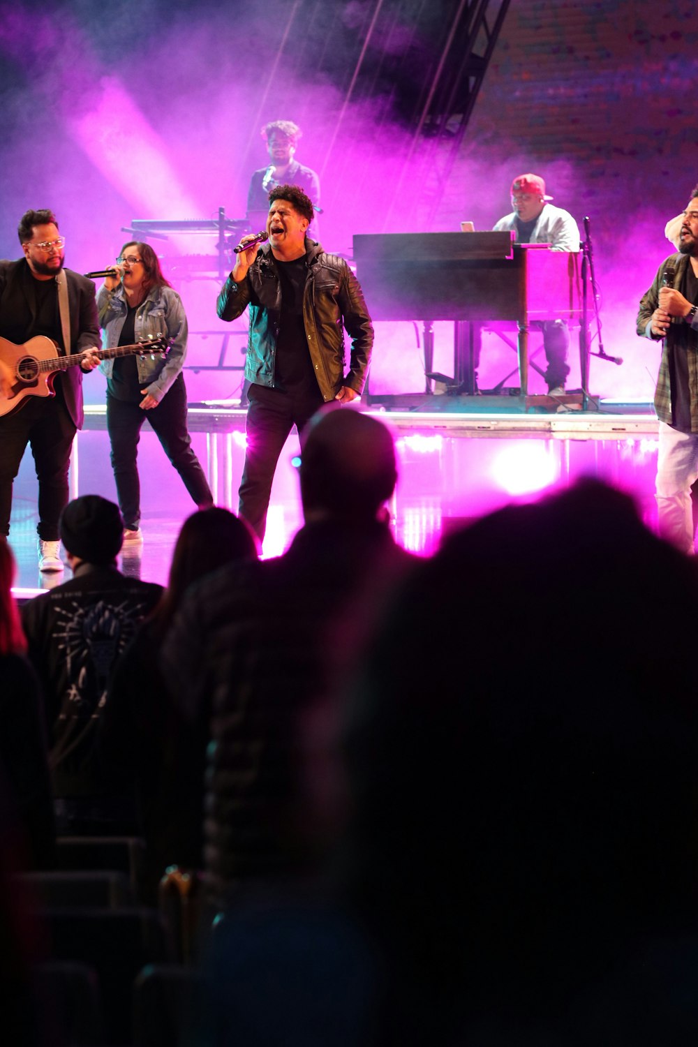 a group of people on a stage in front of a crowd