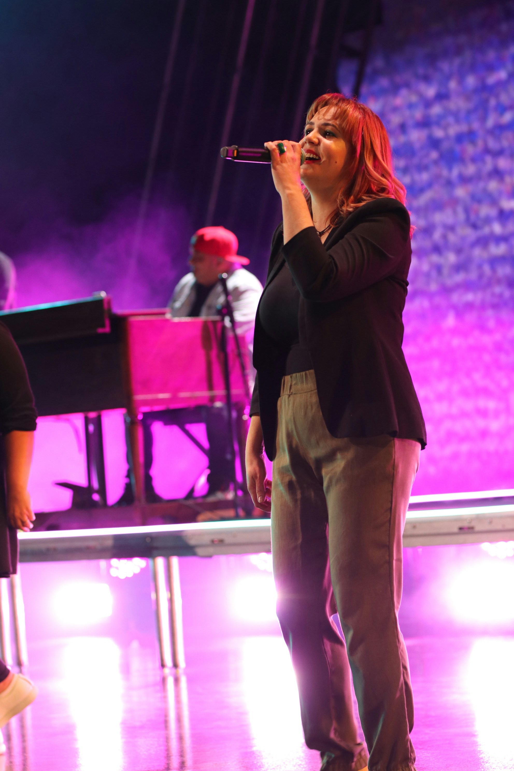 Female singer with microphone on stage