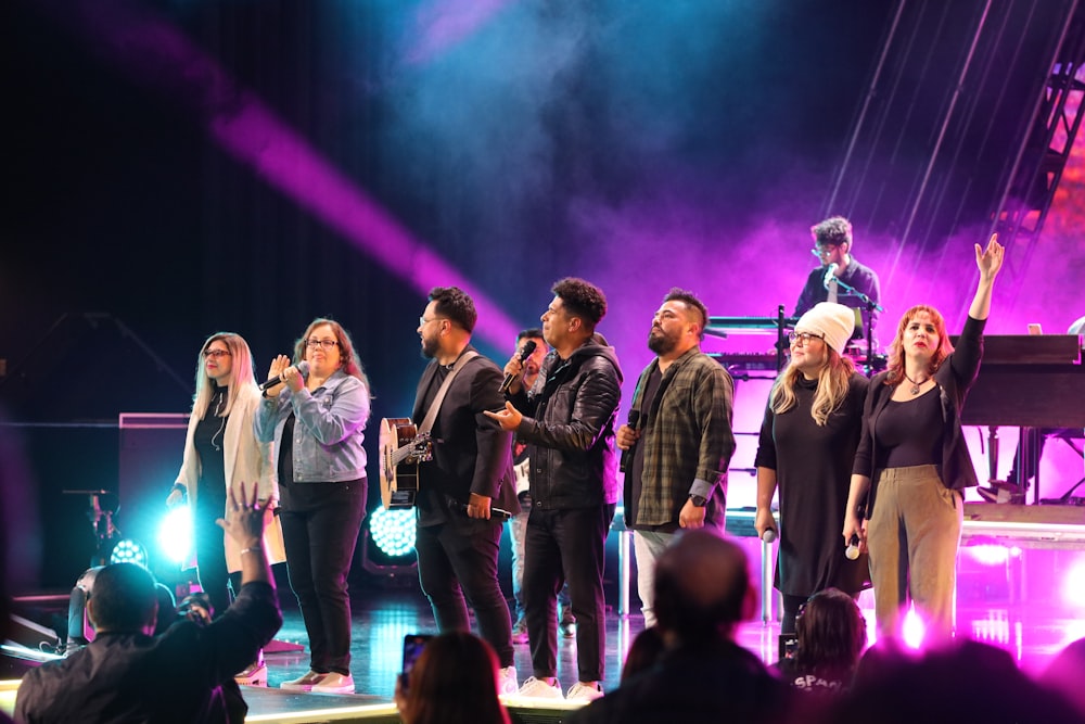 a group of people standing on top of a stage