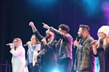 a group of people standing on top of a stage