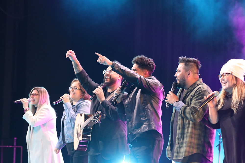 a group of people standing on top of a stage