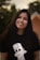 a woman with long dark hair wearing a t - shirt with a dog on it