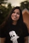 a woman with long dark hair wearing a t - shirt with a dog on it
