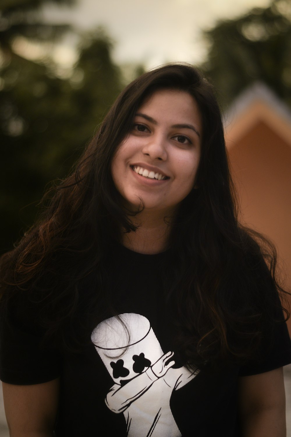 a woman with long dark hair wearing a t - shirt with a dog on it