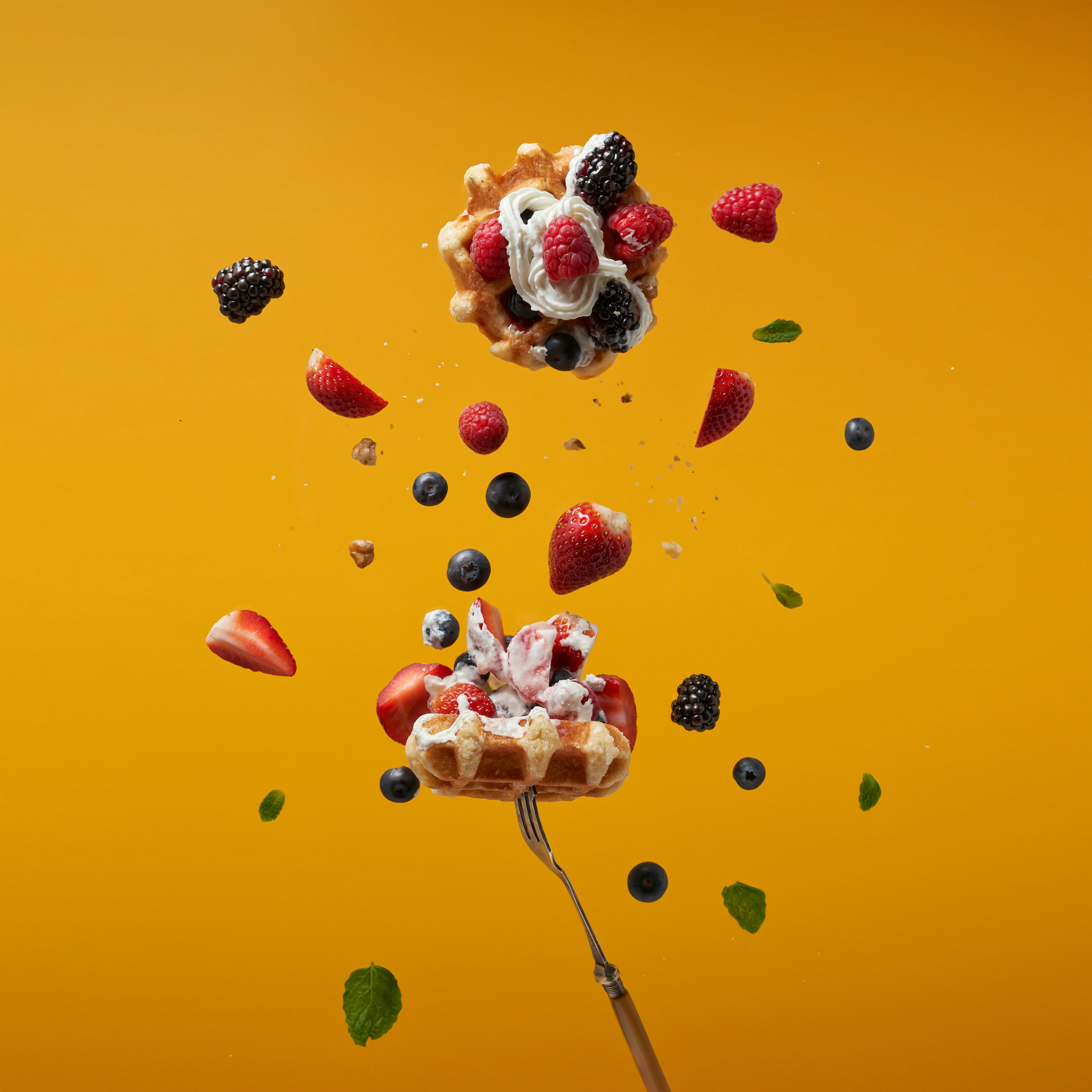 a spoon with a dessert on top of it