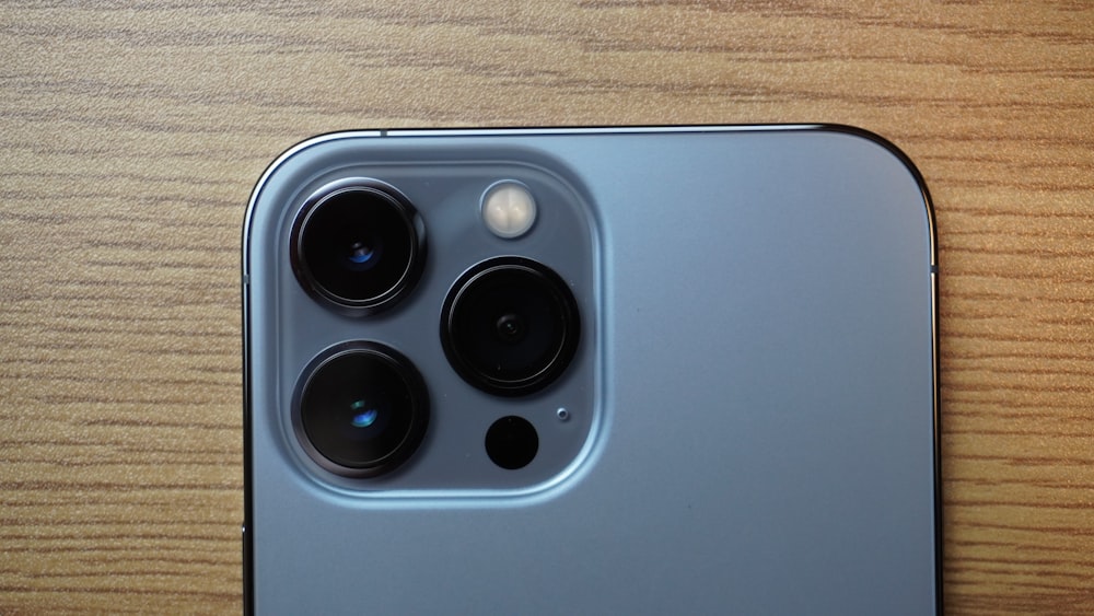 a close up of a cell phone on a wooden surface