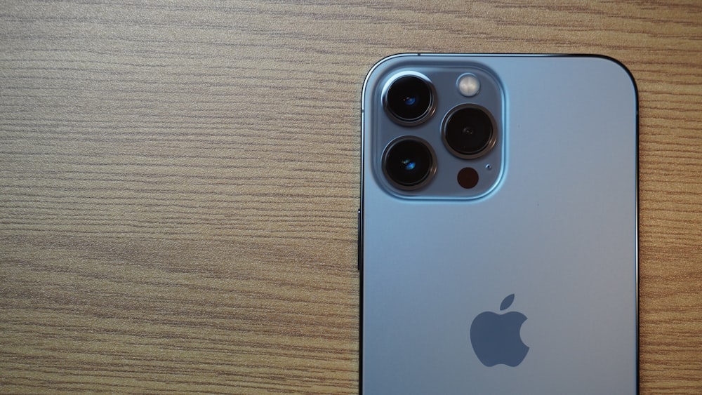 a close up of an iphone on a wooden surface