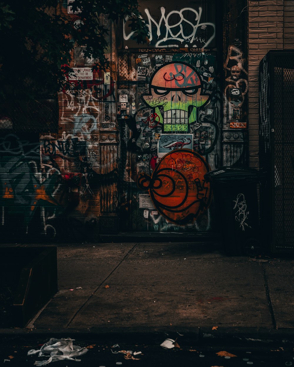 a door covered in graffiti next to a building