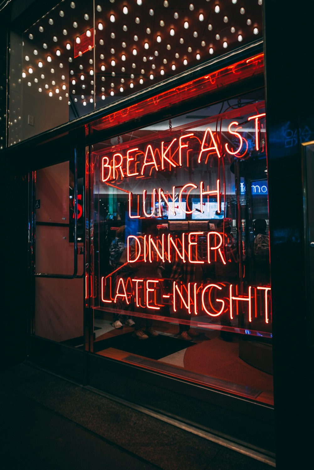 a neon sign in the window of a restaurant