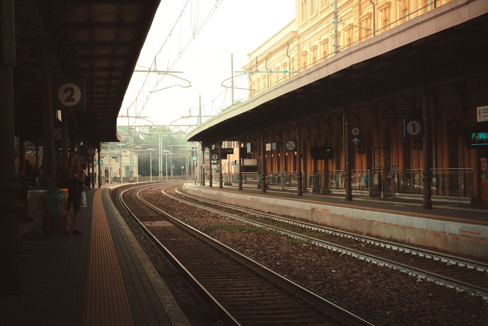 a train station with a train on the tracks