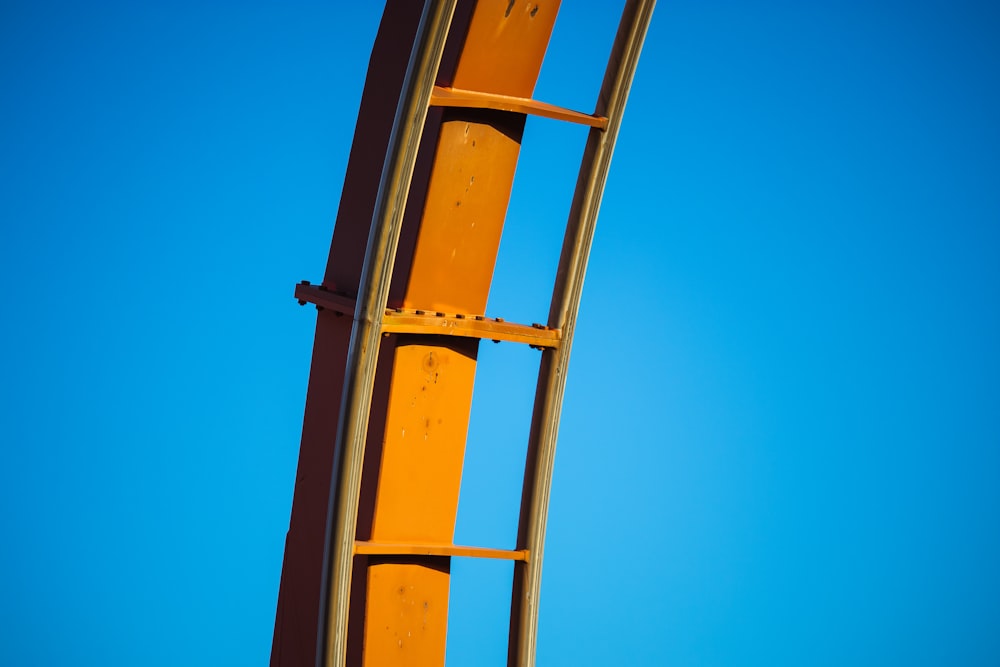 a yellow metal ladder against a blue sky