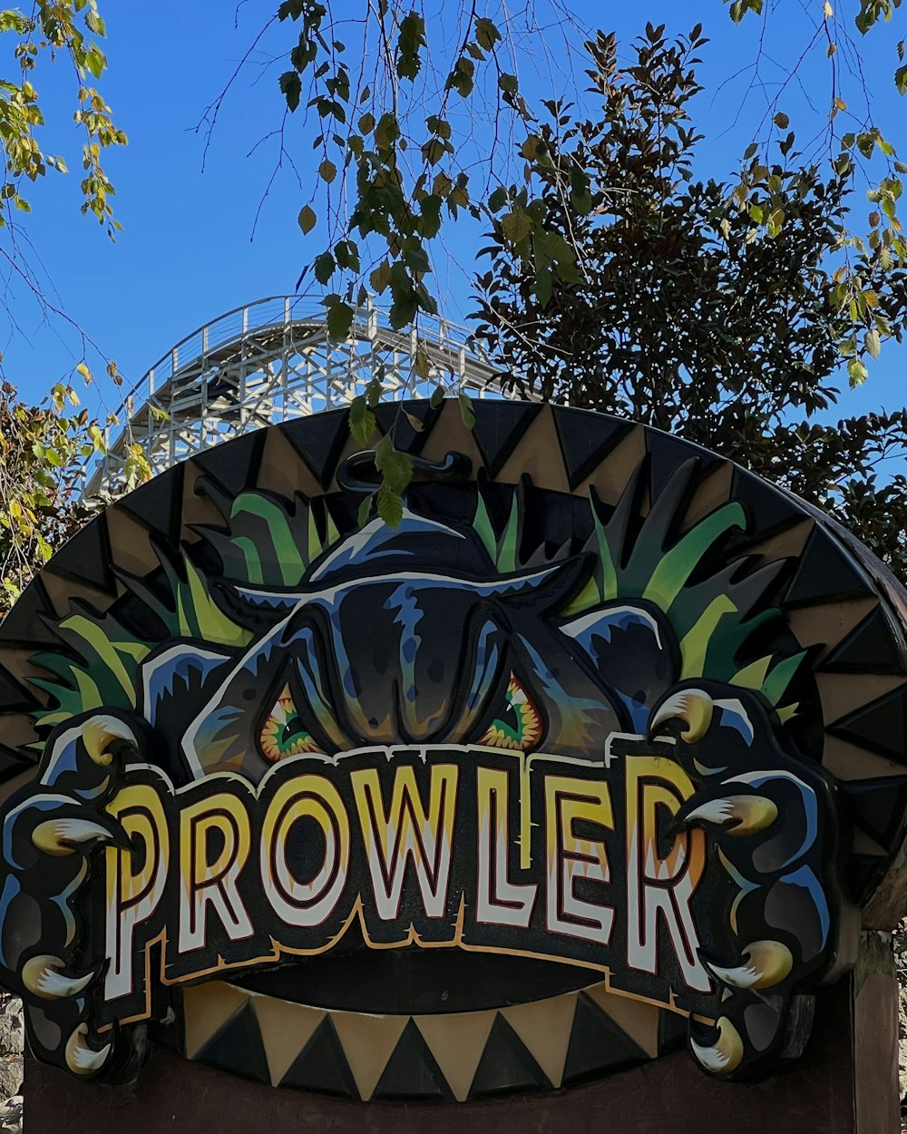 a sign that says prowller in front of some trees