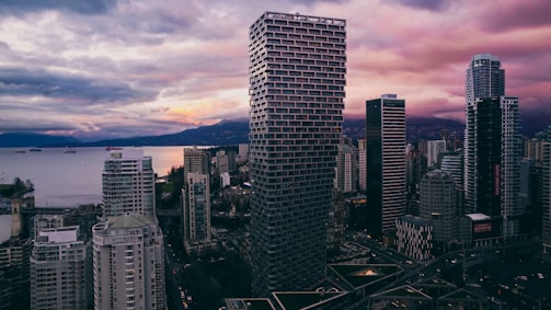 a view of a city with tall buildings and a body of water