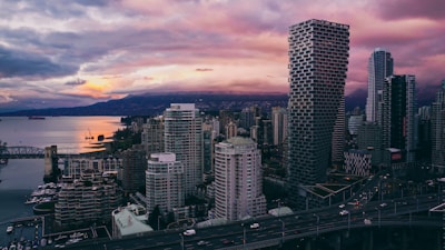 a view of a city with a bridge and a large body of water