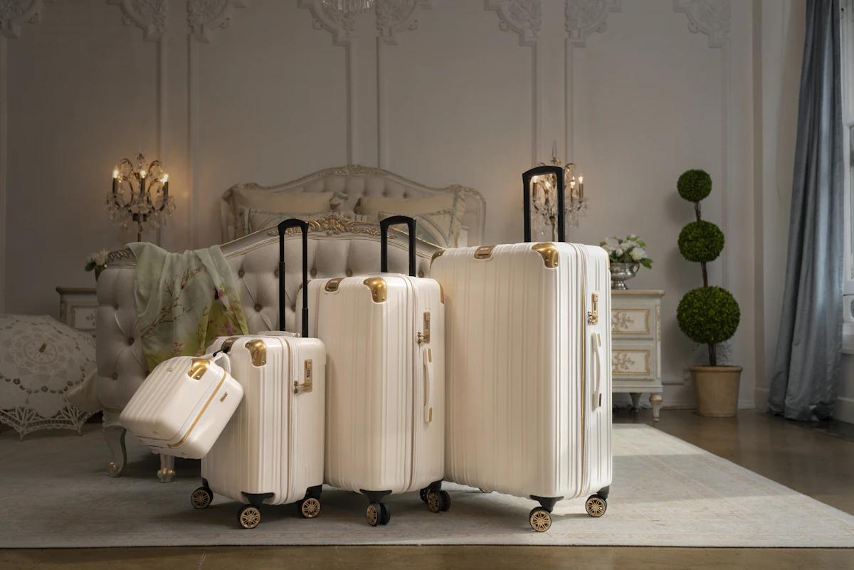 Four packed travel suitcases standing together on a patterned rug before a trip