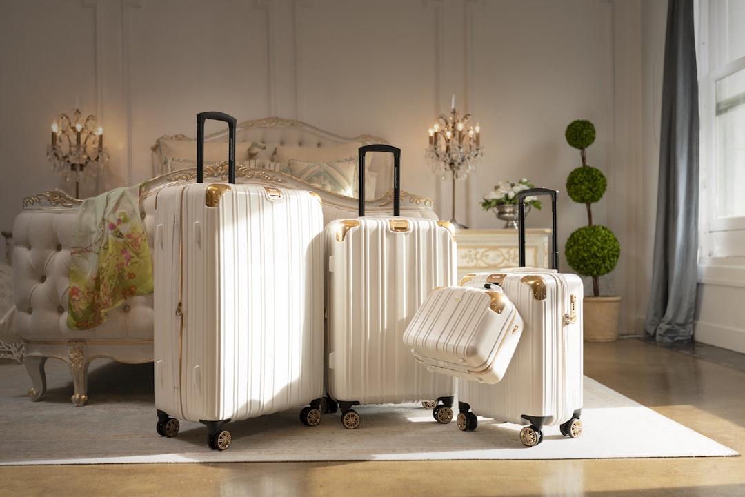 three pieces of white luggage sitting in a room,