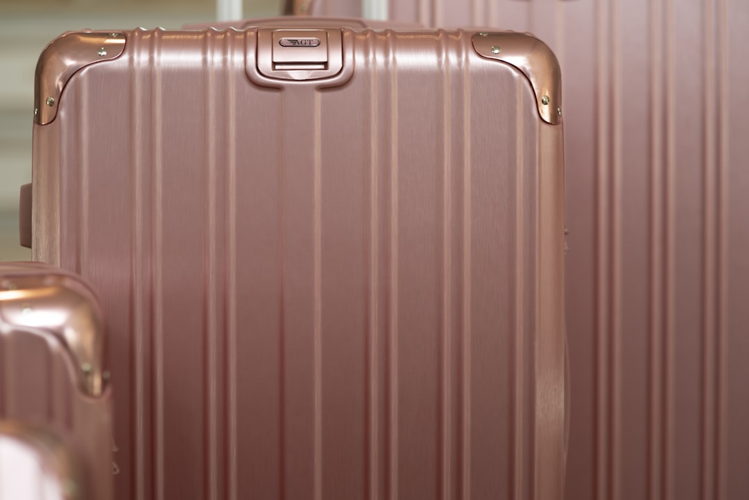 three pieces of pink luggage sitting next to each other,