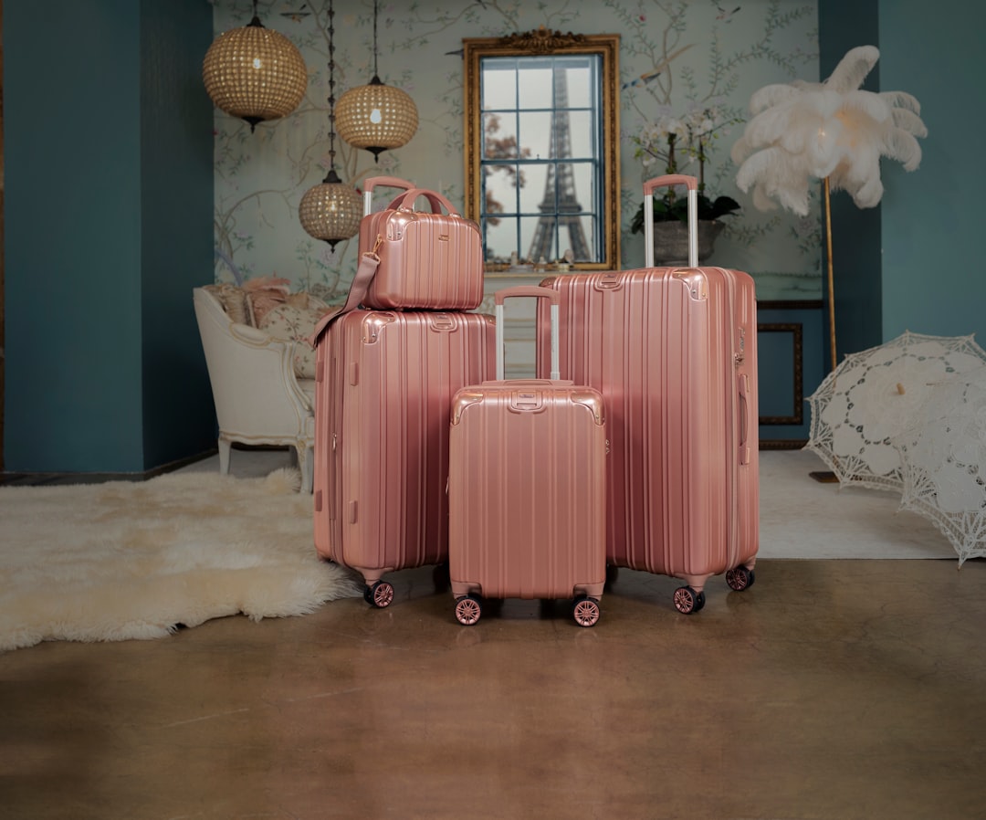 three pieces of pink luggage sitting in a room,