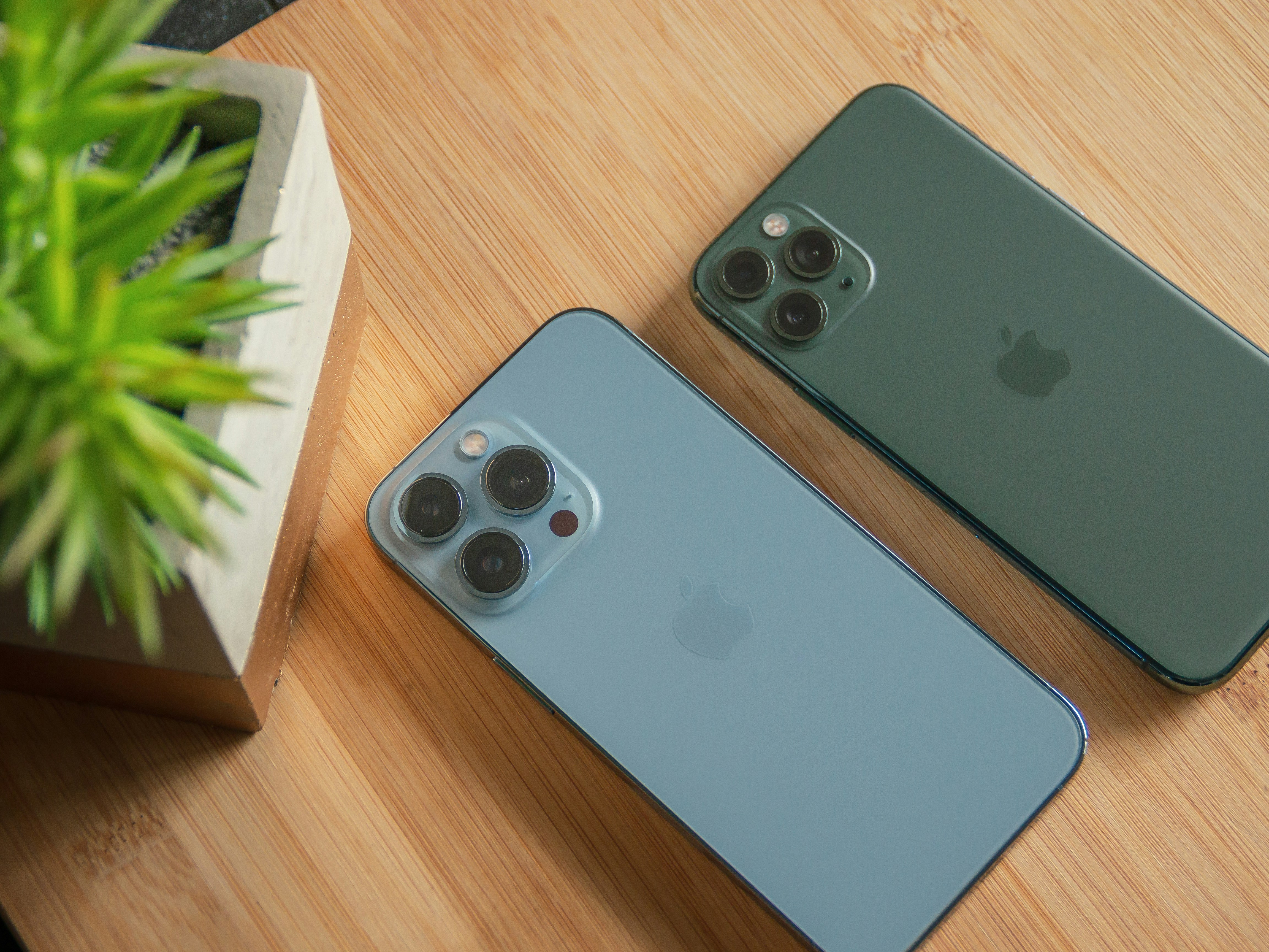 two iphones sitting next to each other on a table