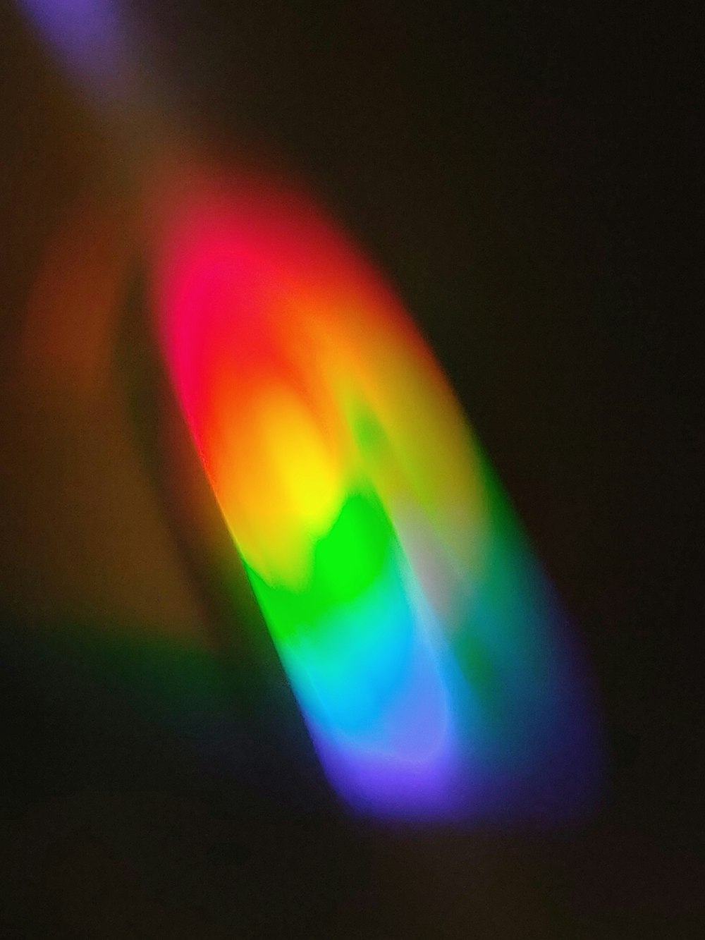 a blurry image of a rainbow colored object