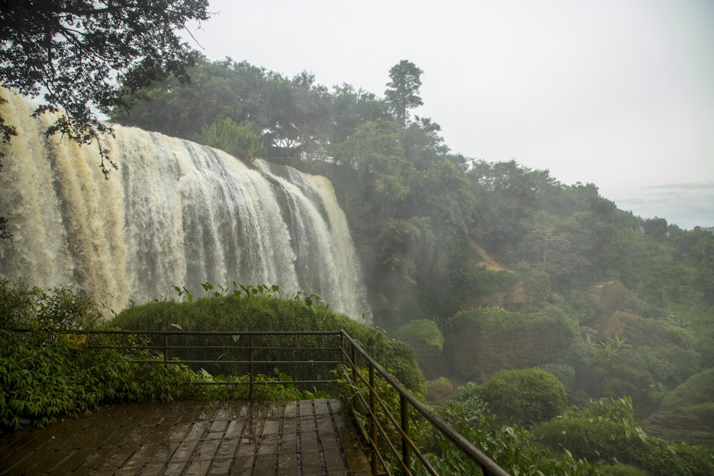 a view of a waterfall from the top of a hill