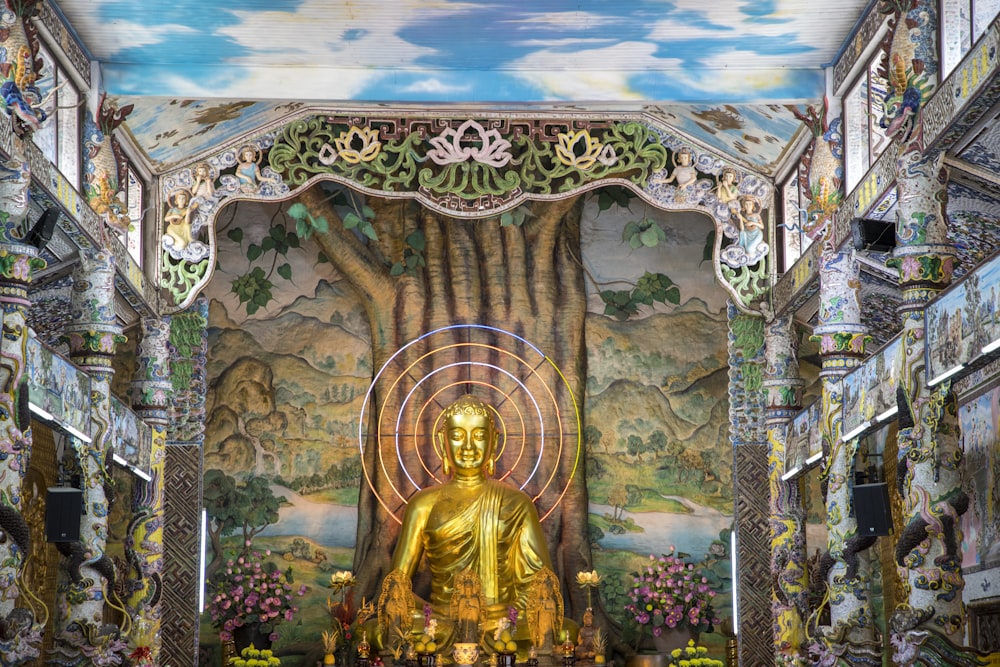 a large golden buddha statue sitting inside of a building