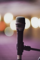 a close up of a microphone with blurry lights in the background