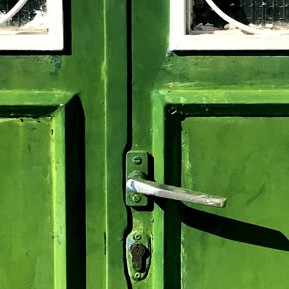 a close up of a green door with a handle