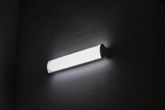 Close-up of a wall washer LED fixture installed in a modern office space.