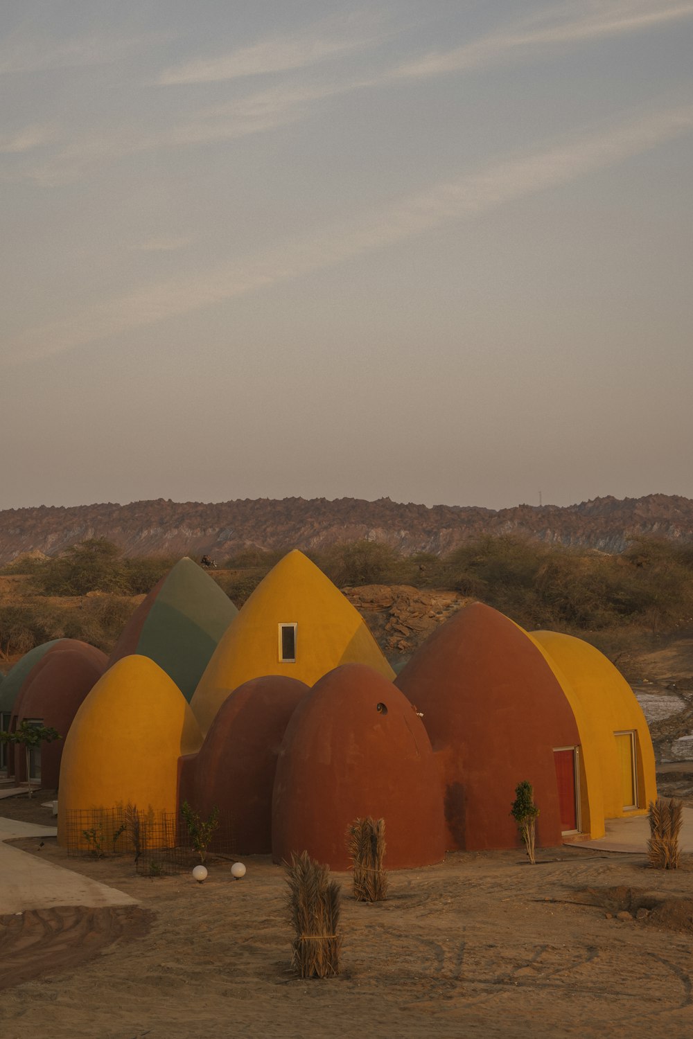 a group of domes in the desert with a sky background